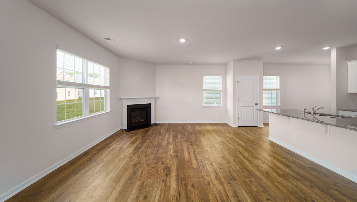 Spacious family room with windows and fireplace