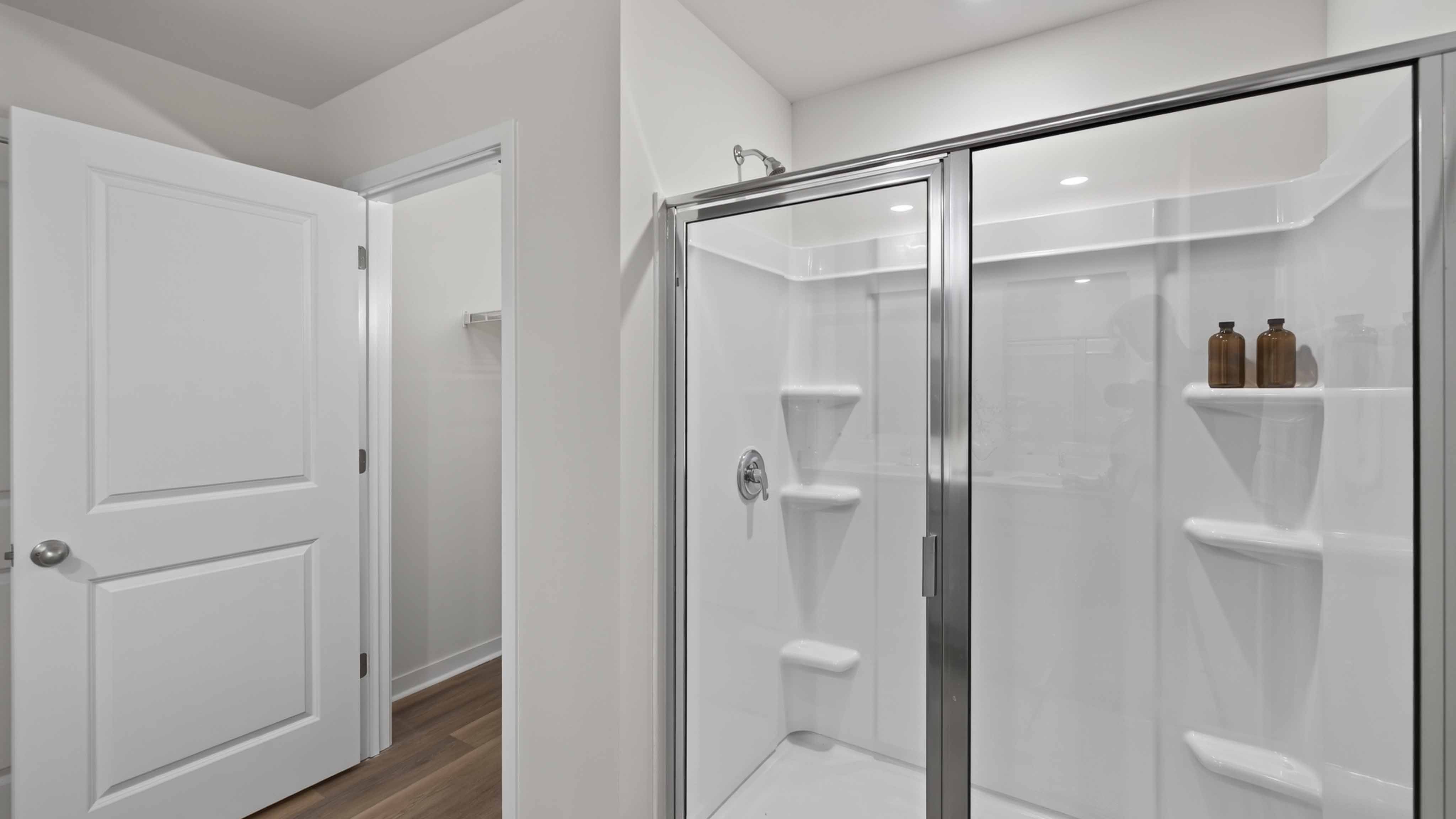 Primary bathroom with double sinks, white cabinets and counters