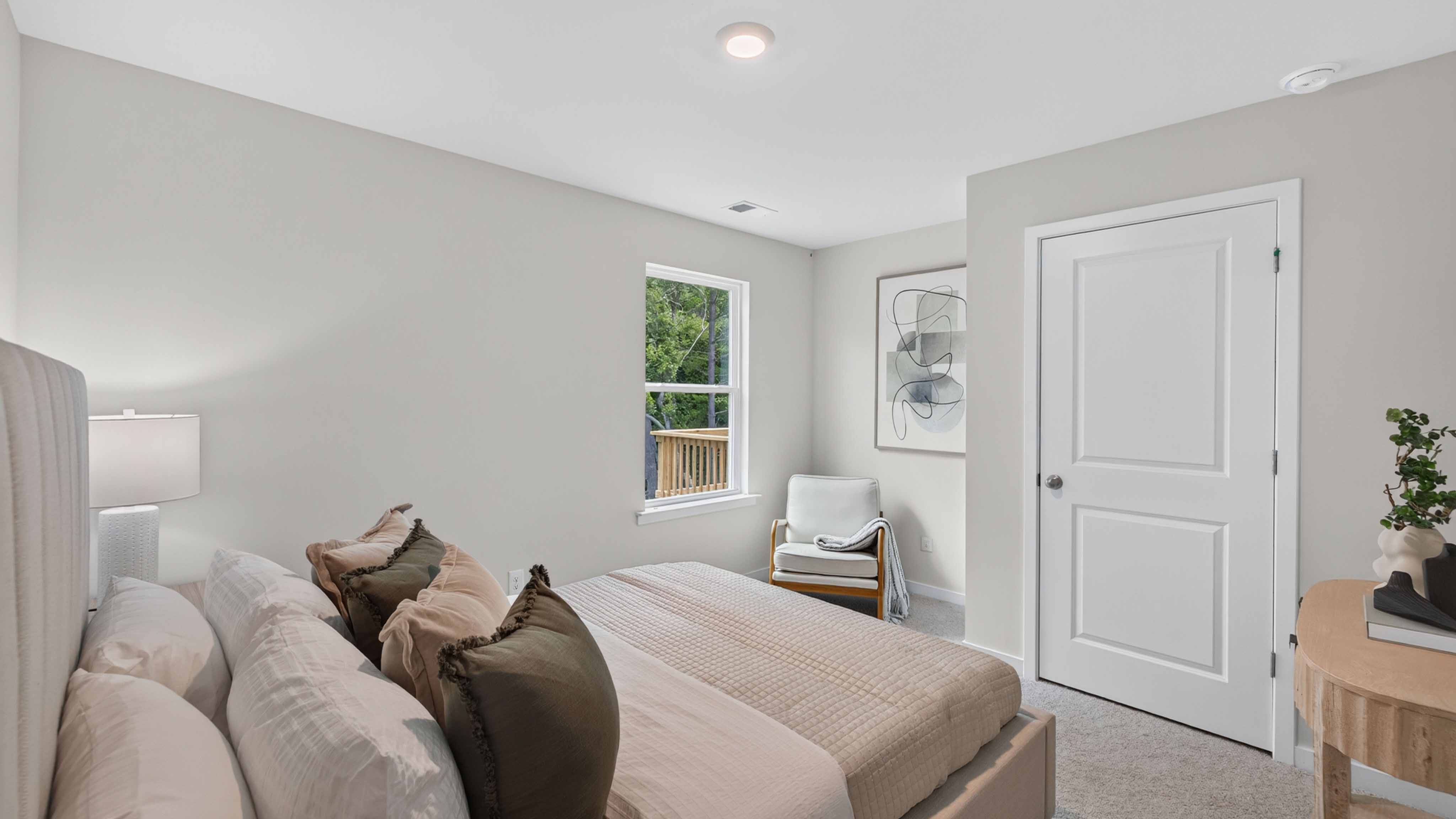 Carpeted bedroom with large window