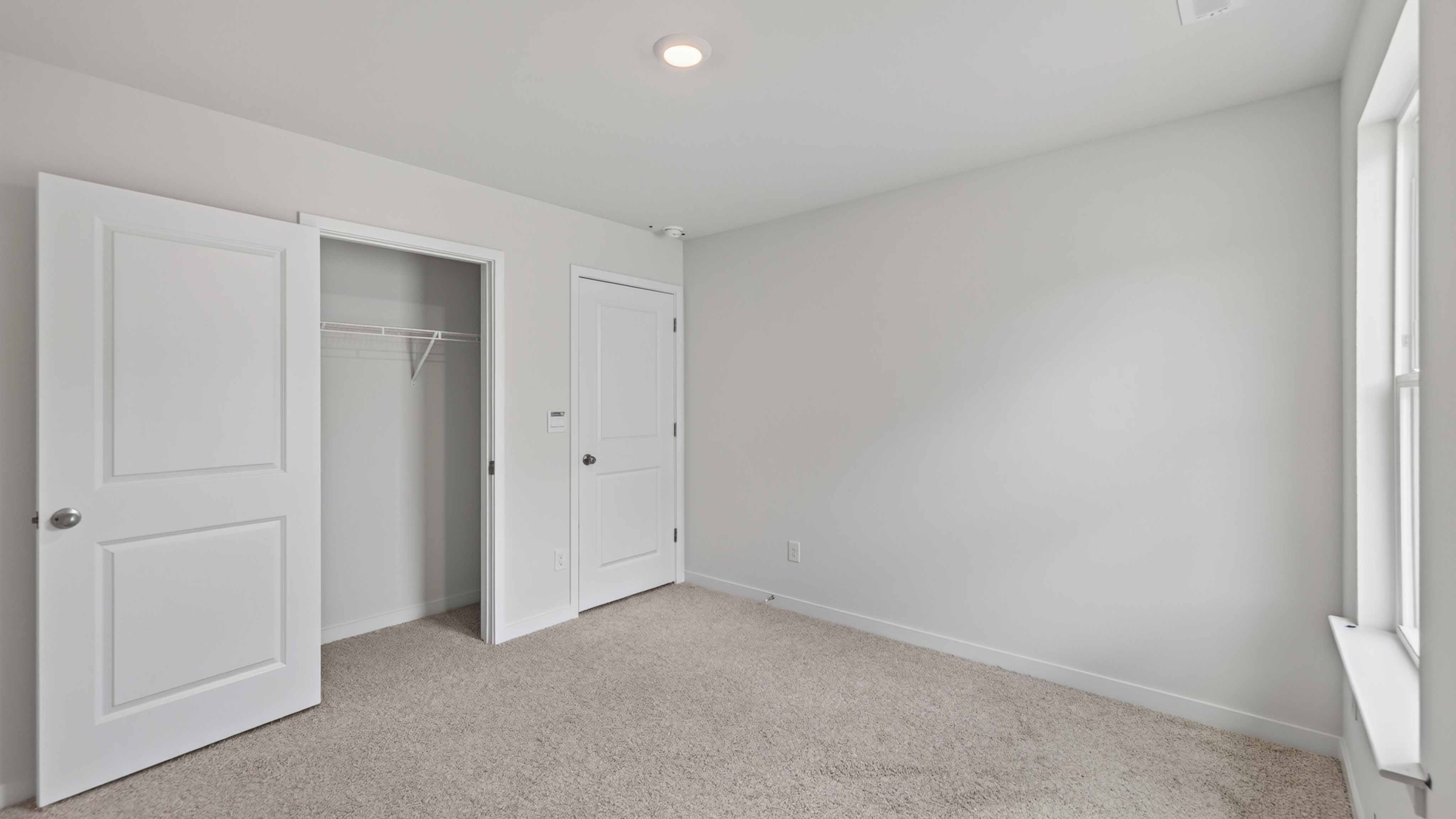 Carpeted bedroom with large window