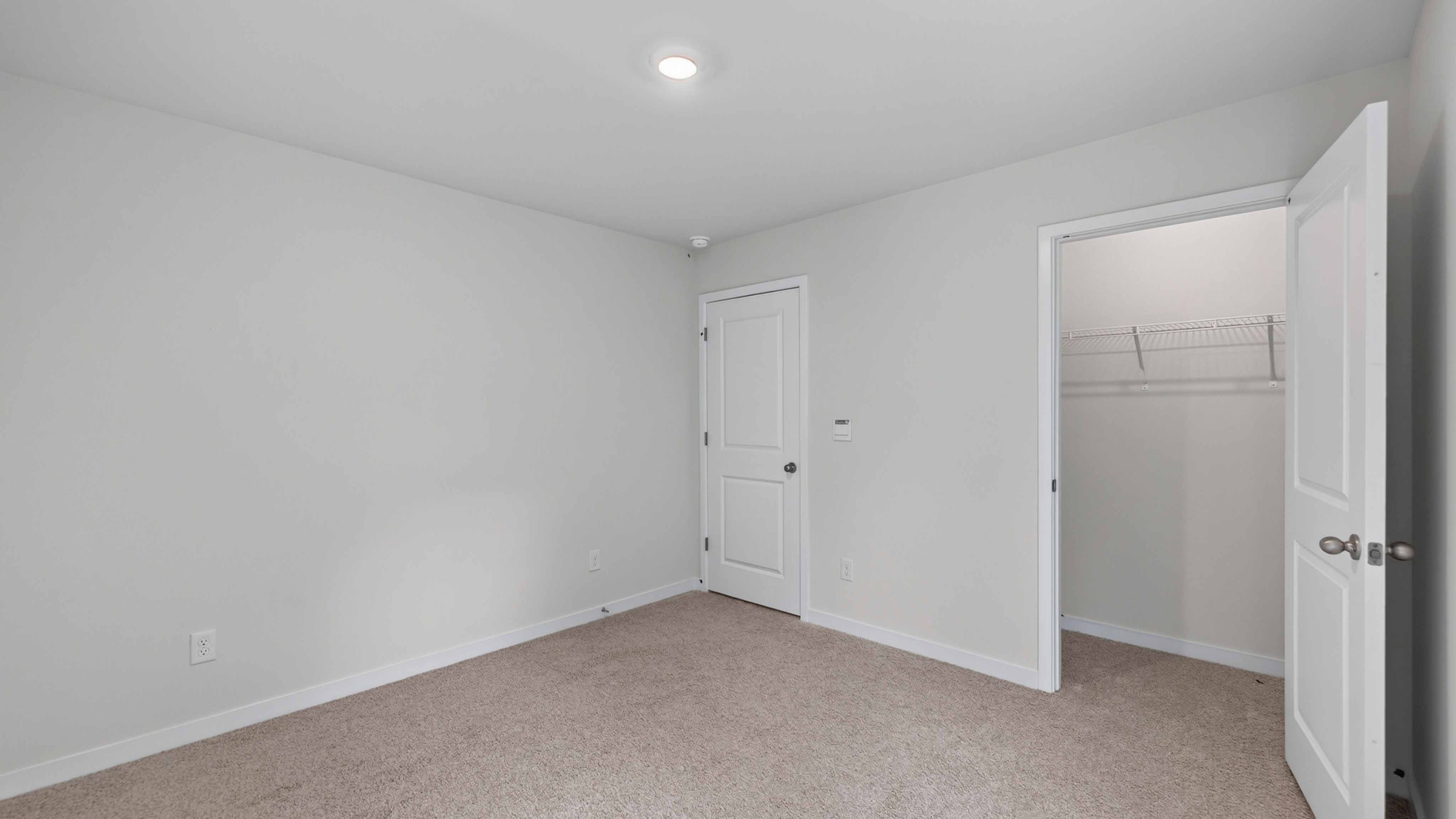 Carpeted bedroom with large window
