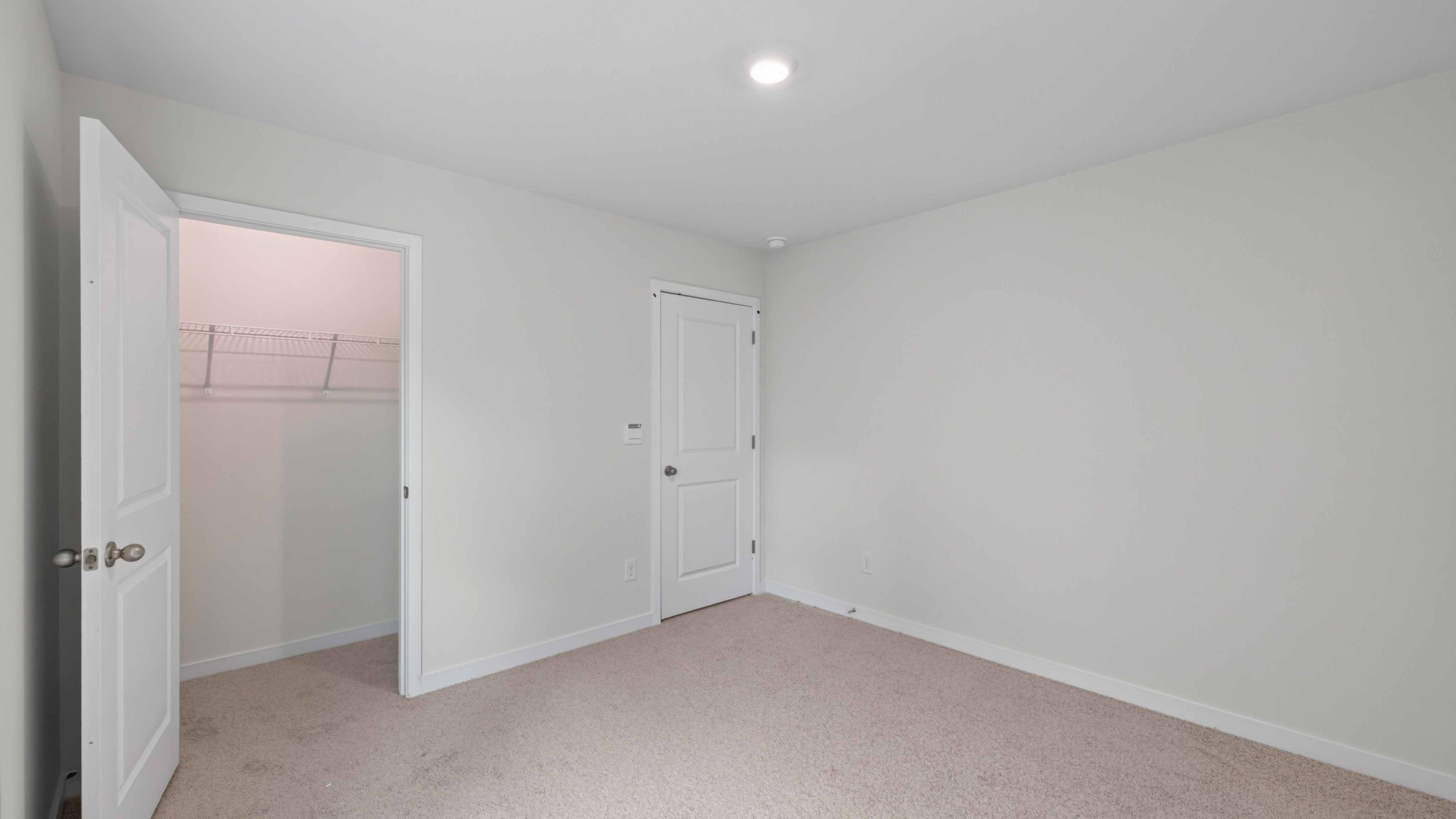 Carpeted bedroom with large window