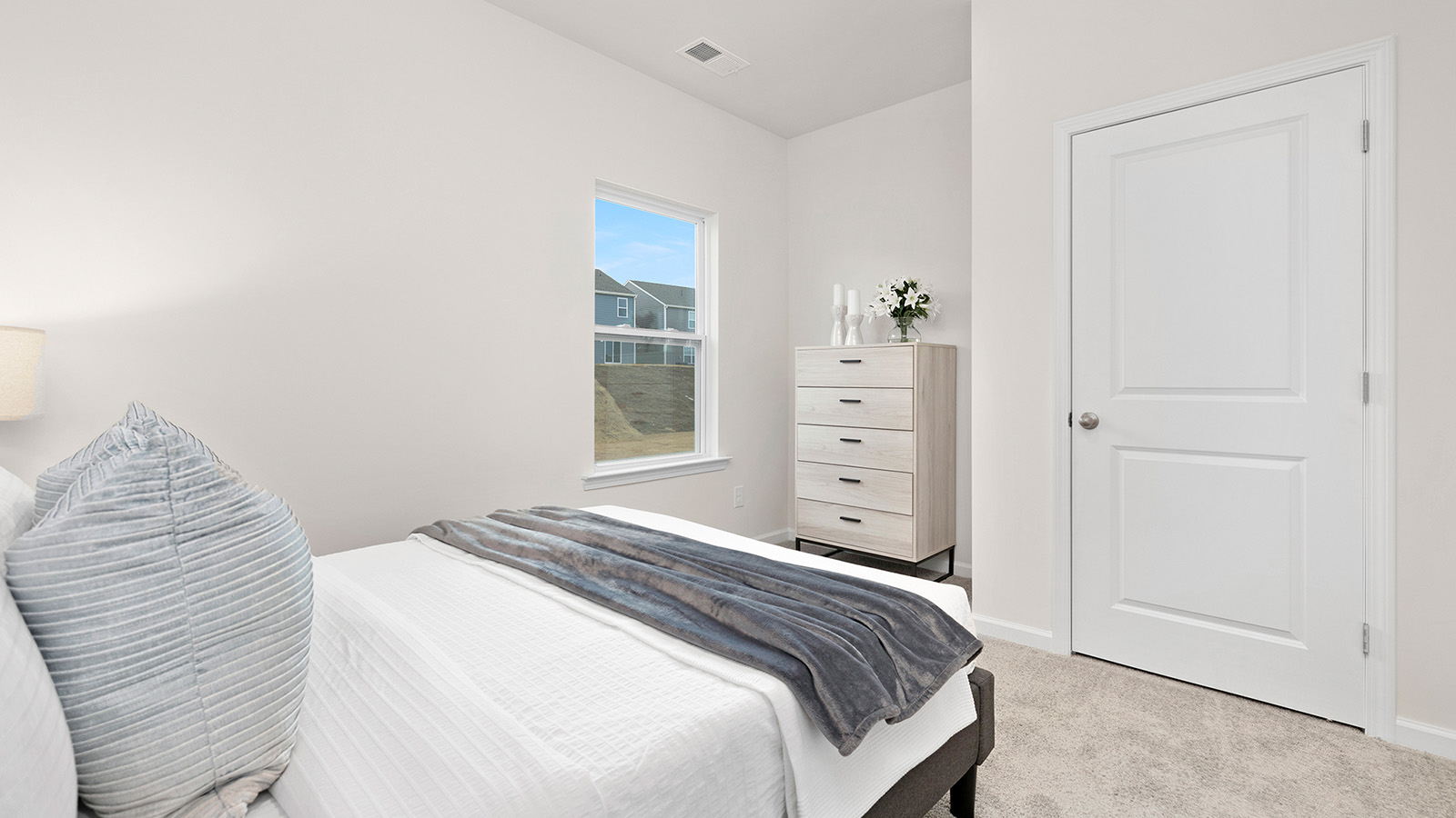 Carpeted bedroom with large window
