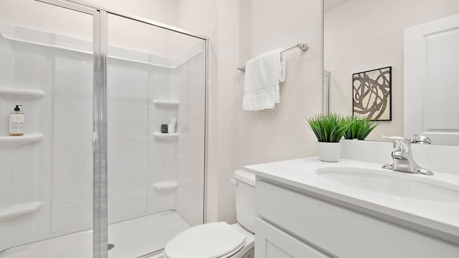 Bathroom with standing shower, white counter and cabinets