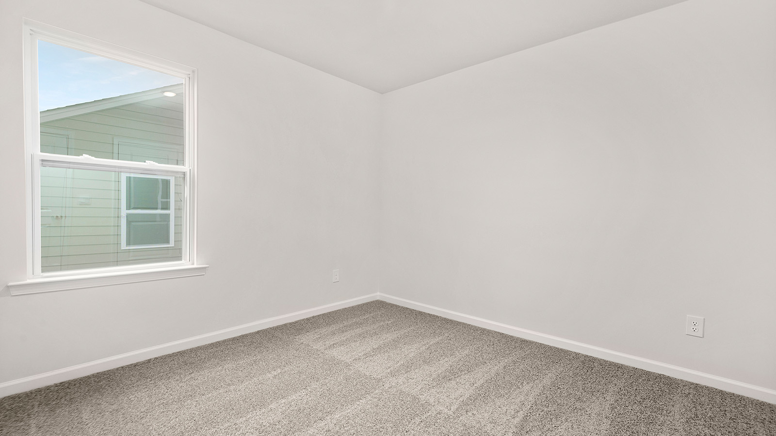 Carpeted bedroom with large window