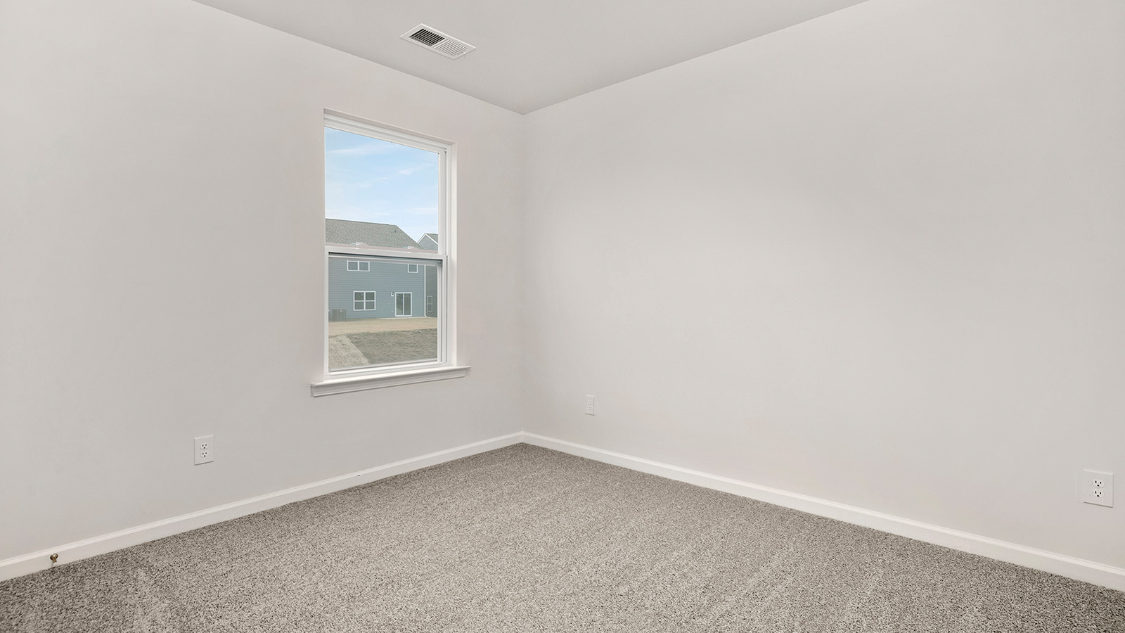 Carpeted bedroom with large window