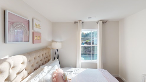 Carpeted bedroom with large window