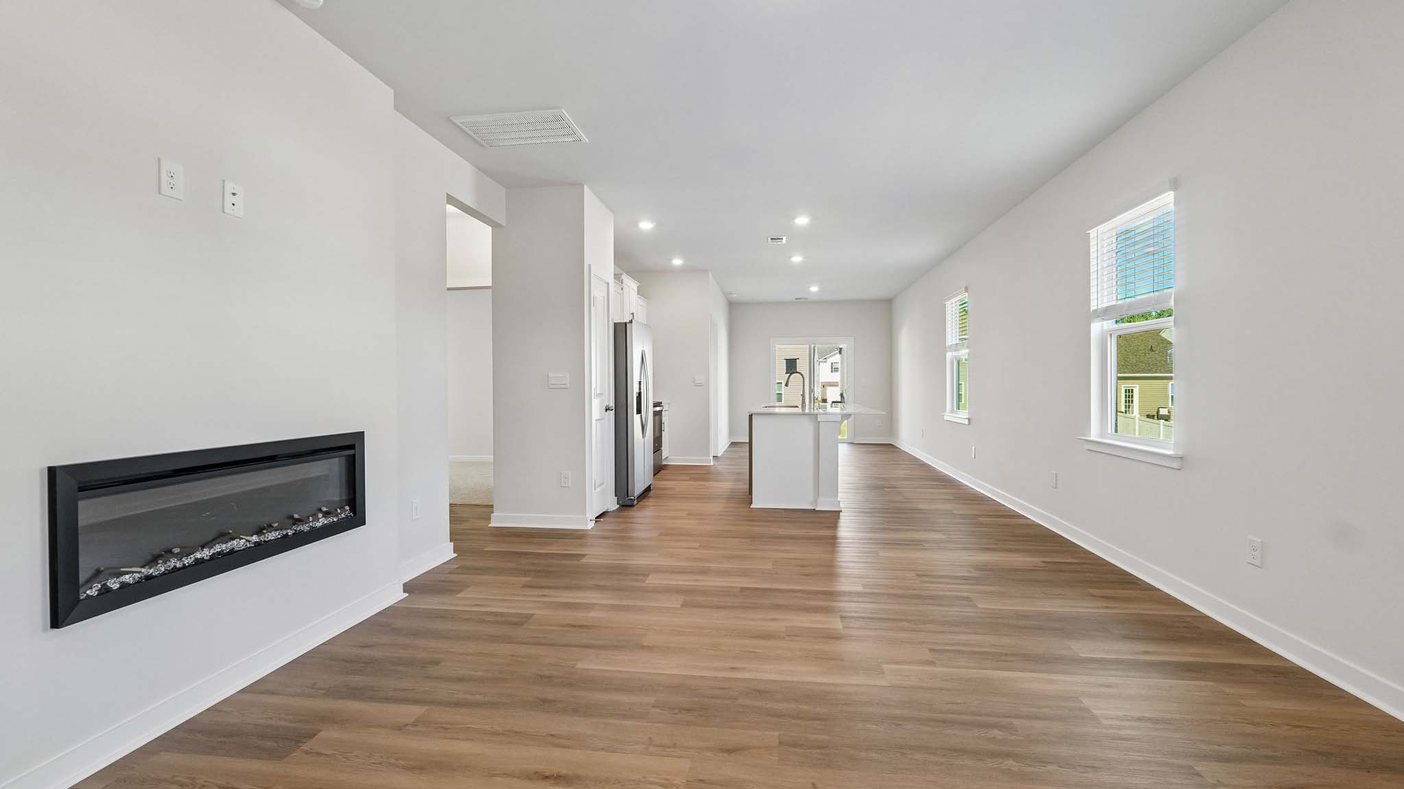 Living room with electric fireplace and windows