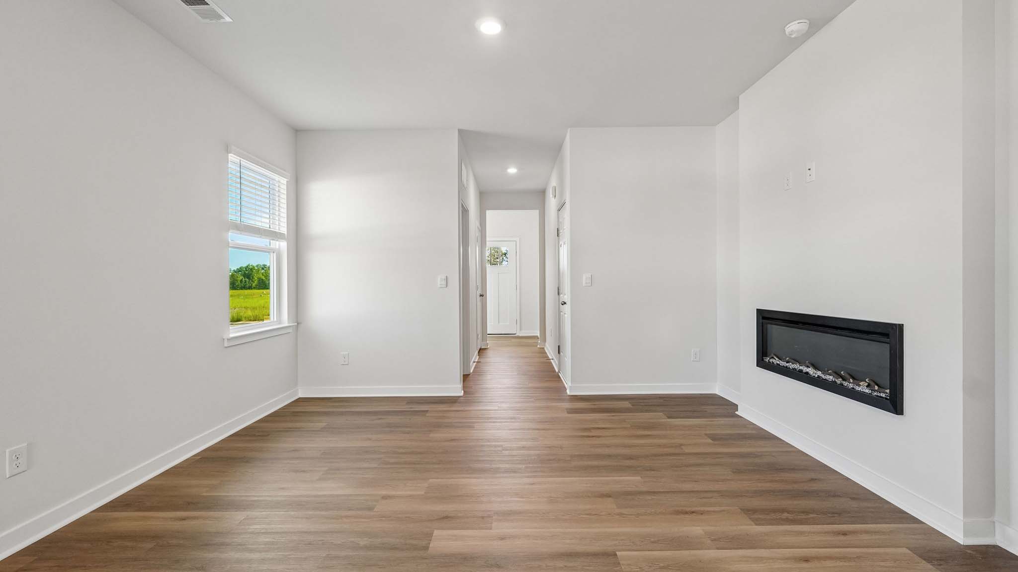 Living room with electric fireplace and windows