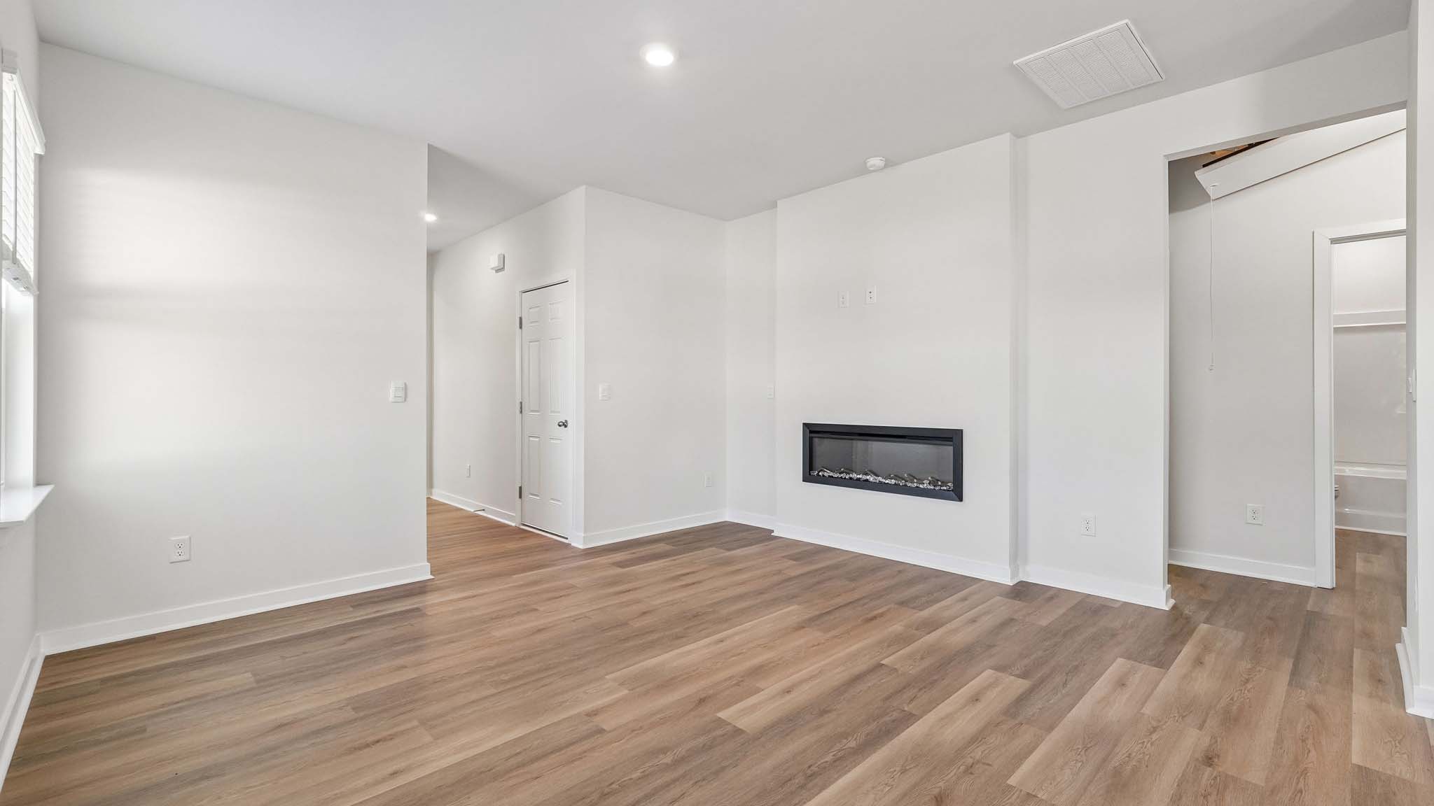 Living room with electric fireplace and windows