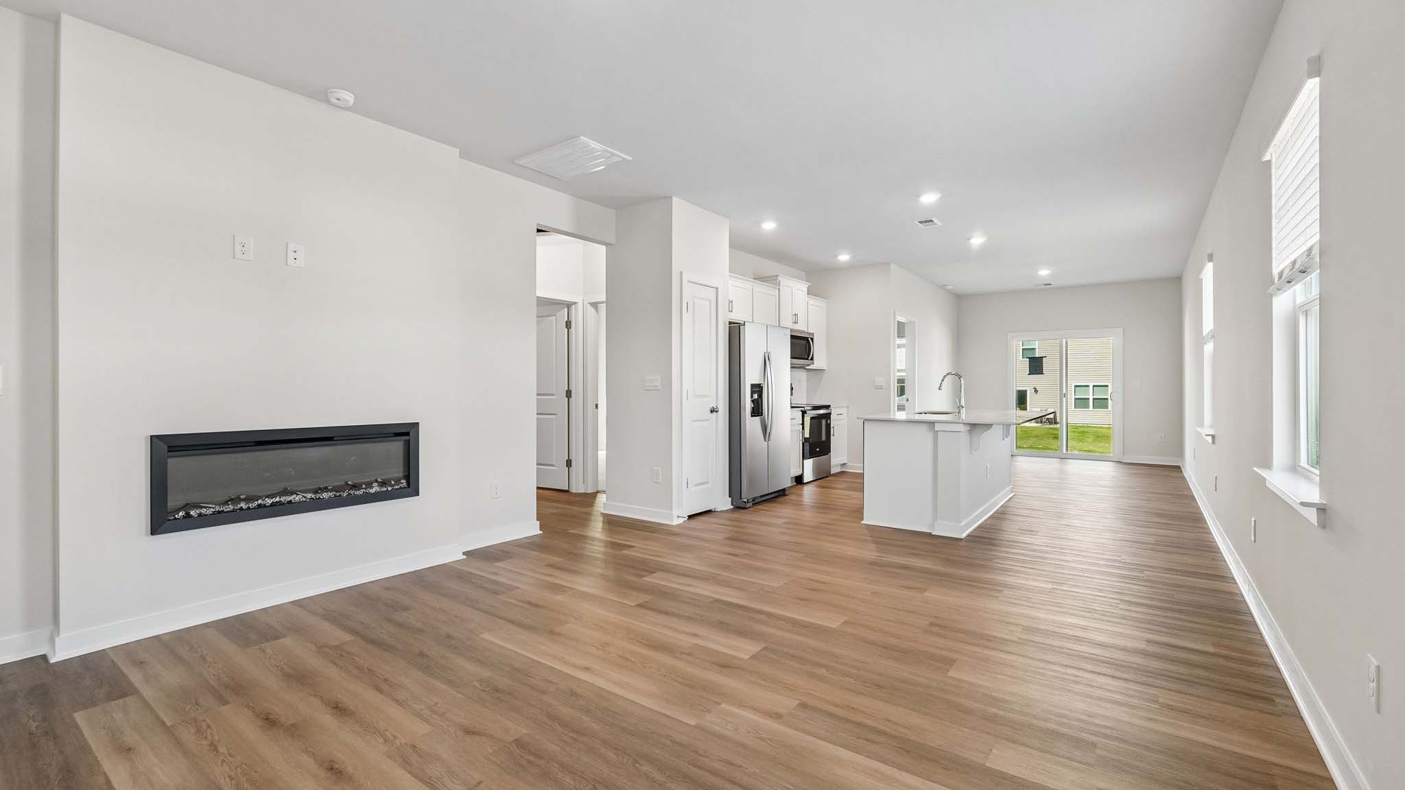Living room with electric fireplace and windows