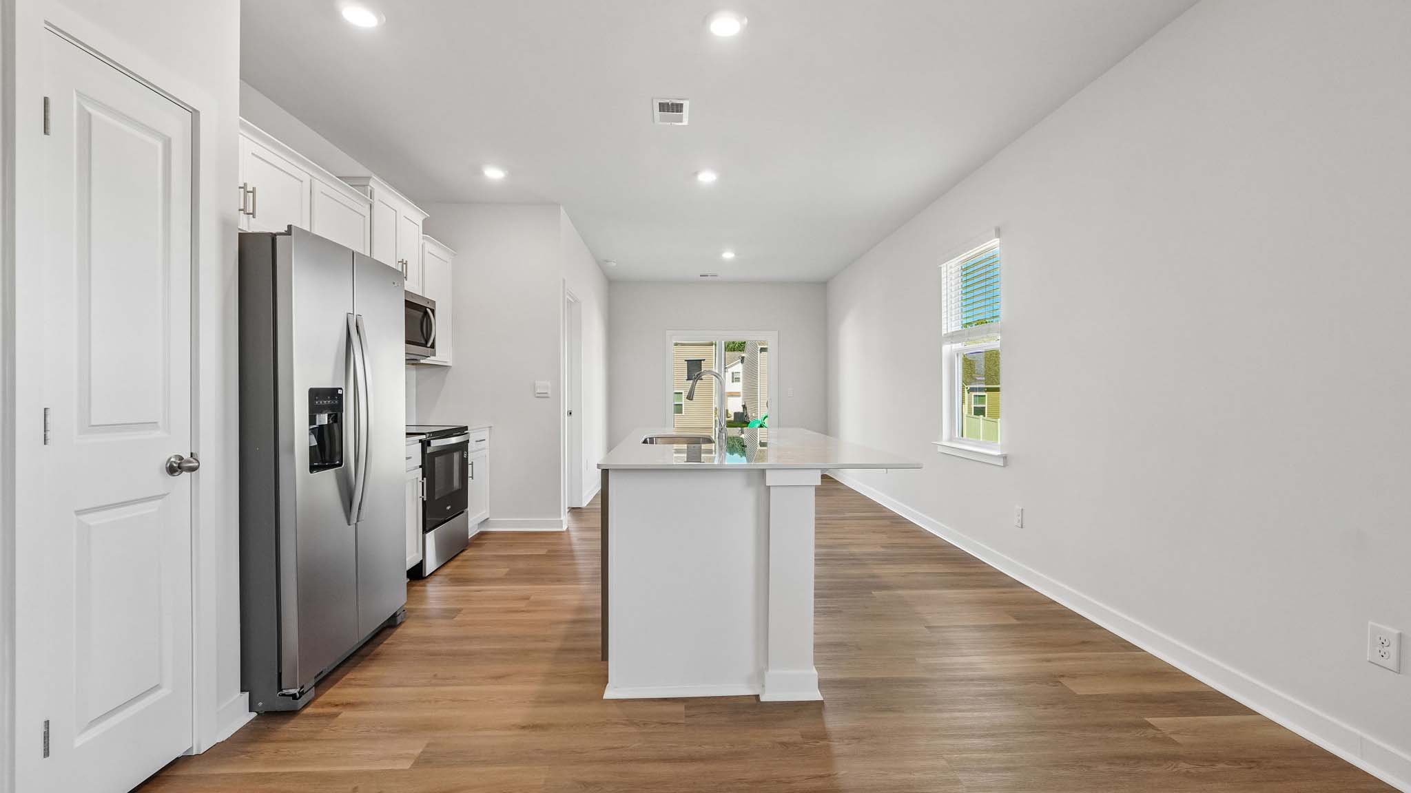 Kitchen and island with white cabinets