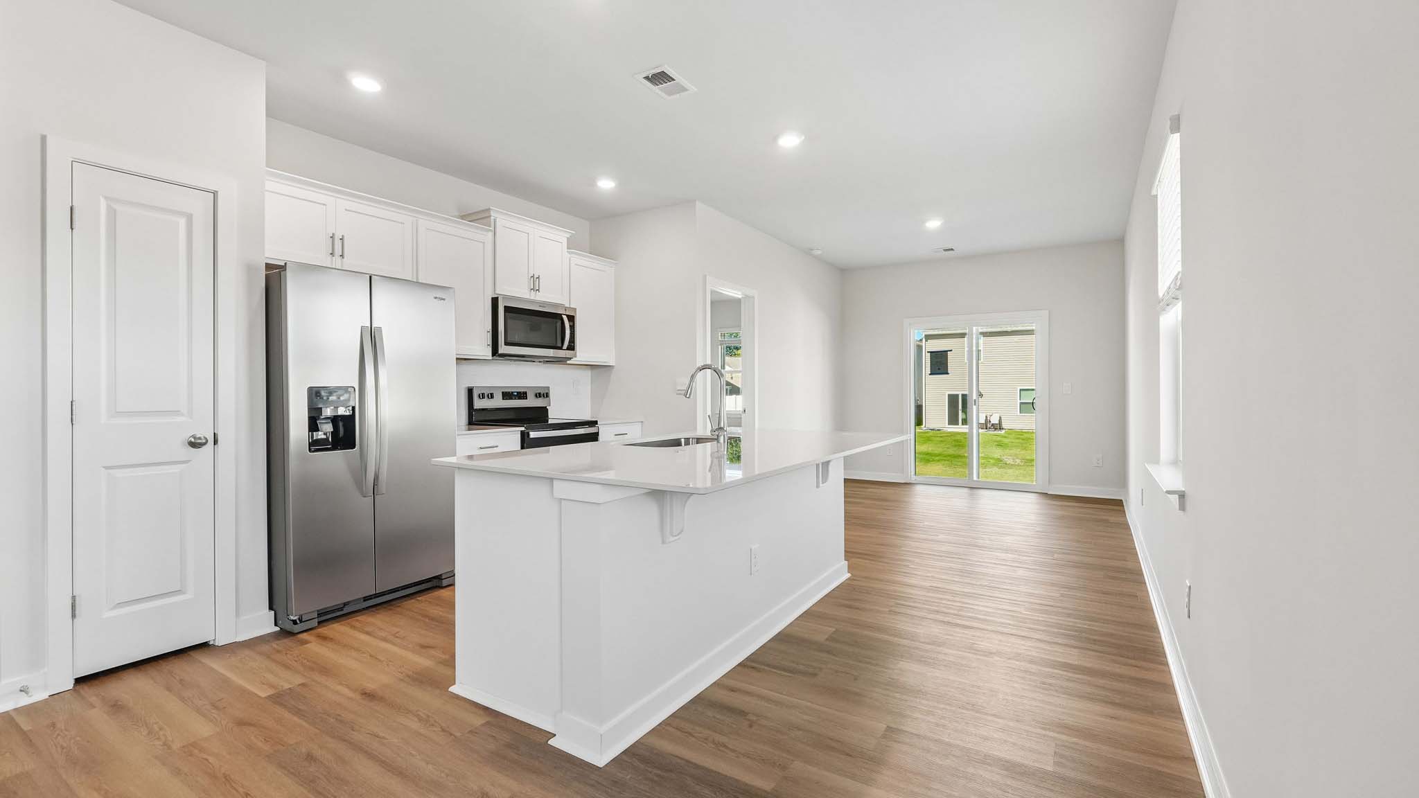 Kitchen and island with white cabinets