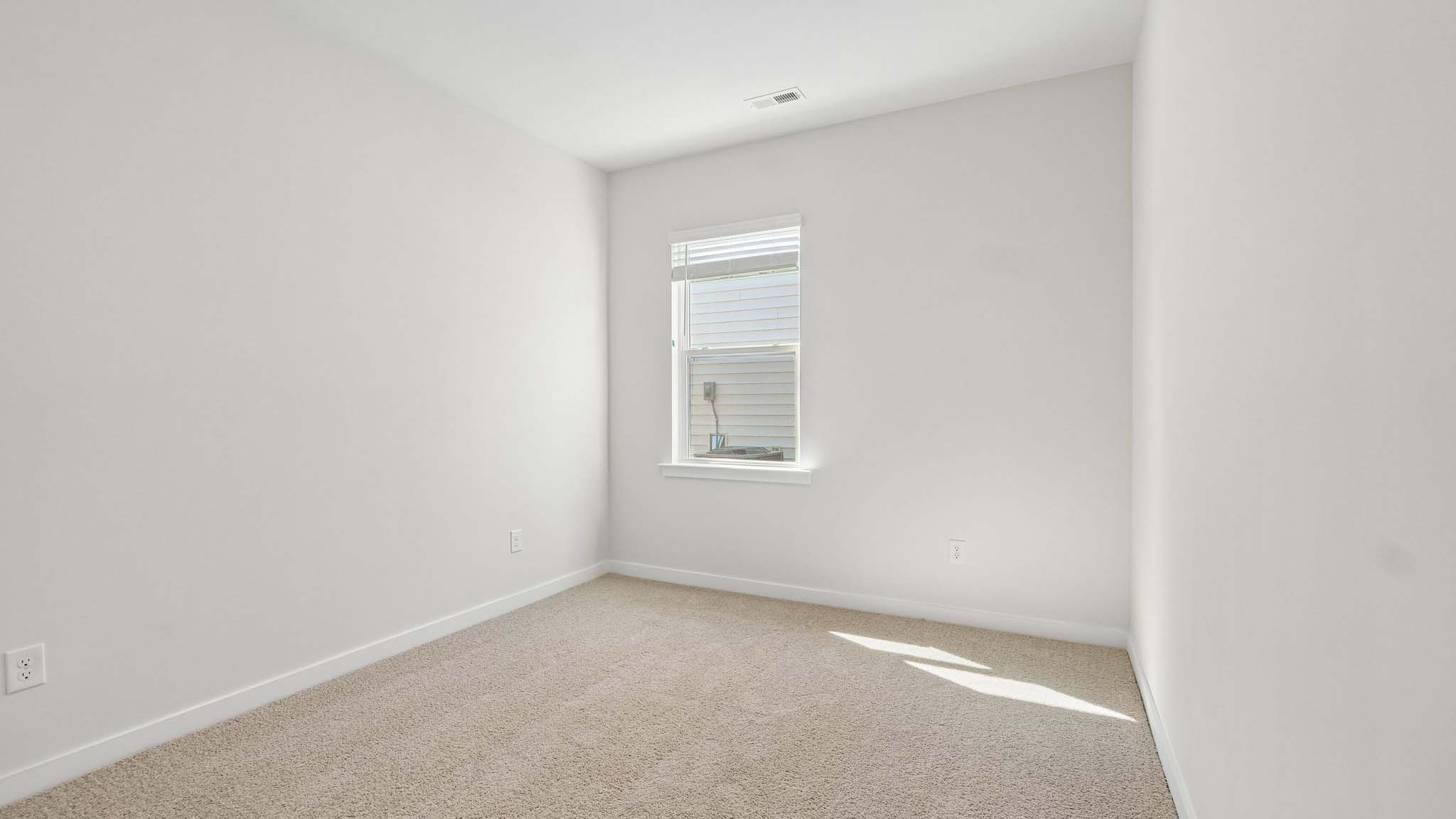 Carpeted bedroom with window
