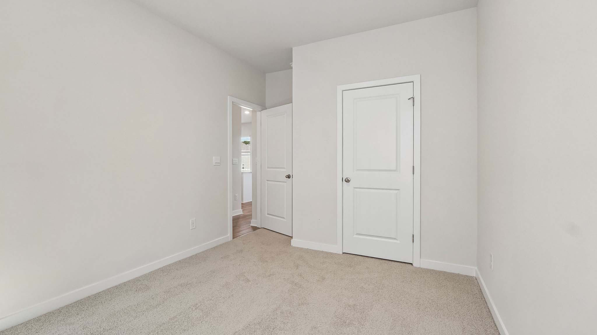Carpeted bedroom with window