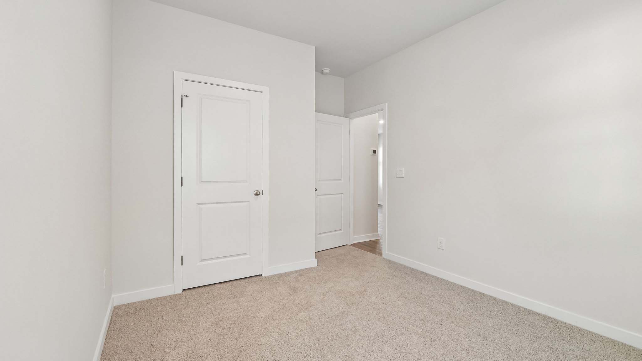 Carpeted bedroom with window