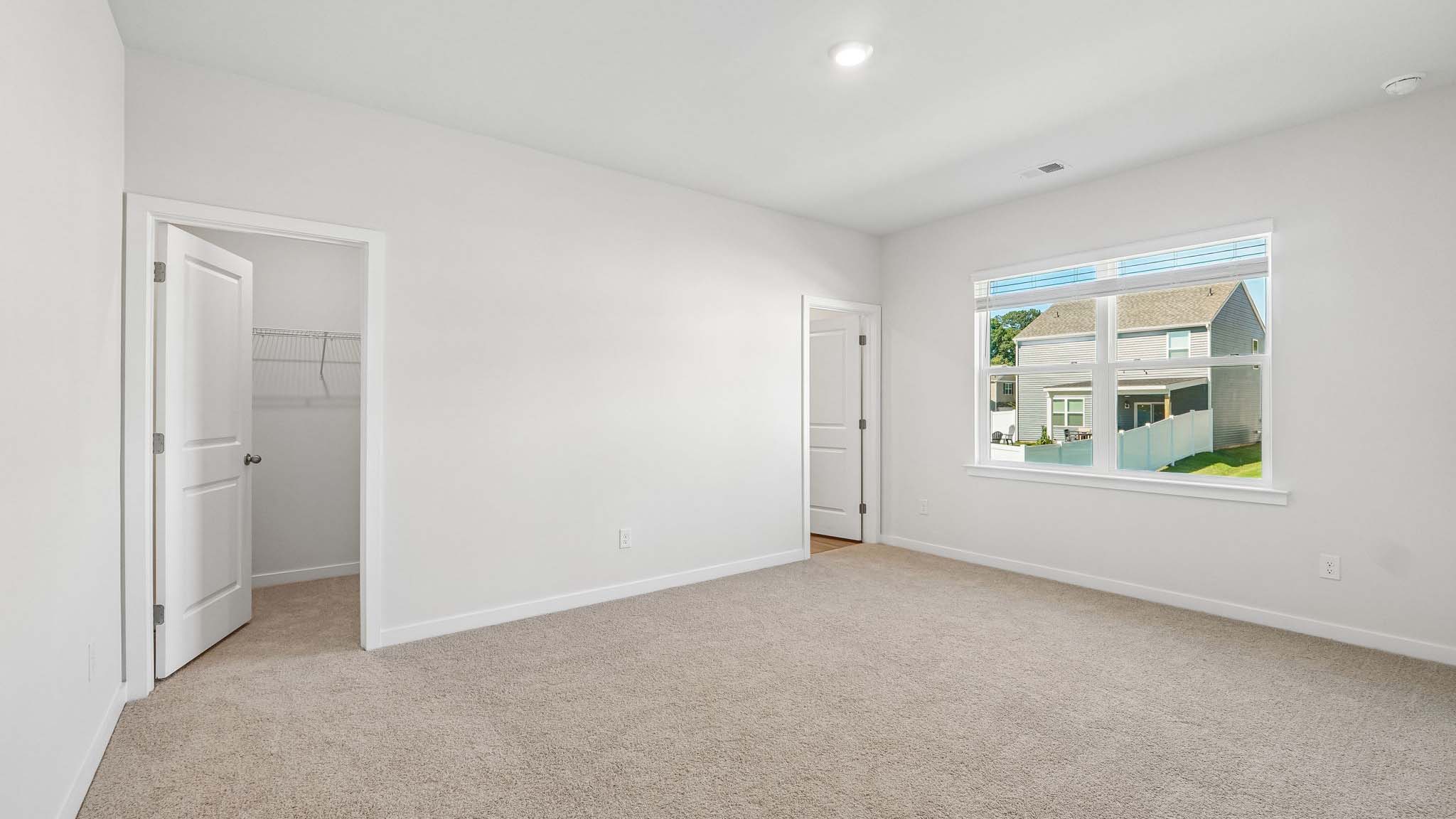 Carpeted bedroom with window