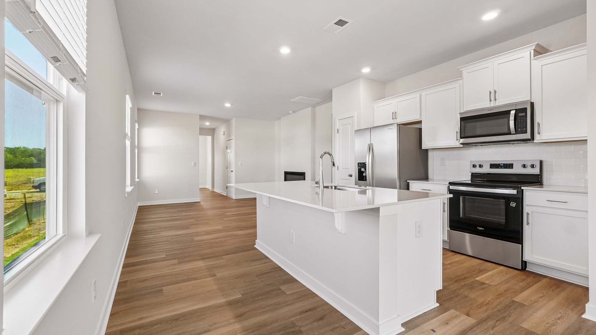 Kitchen and island with white cabinets