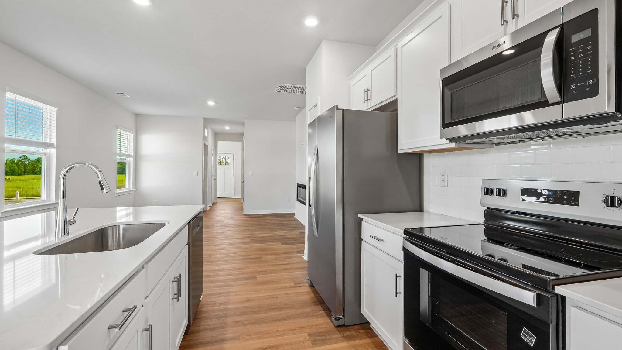 Kitchen and island with white cabinets