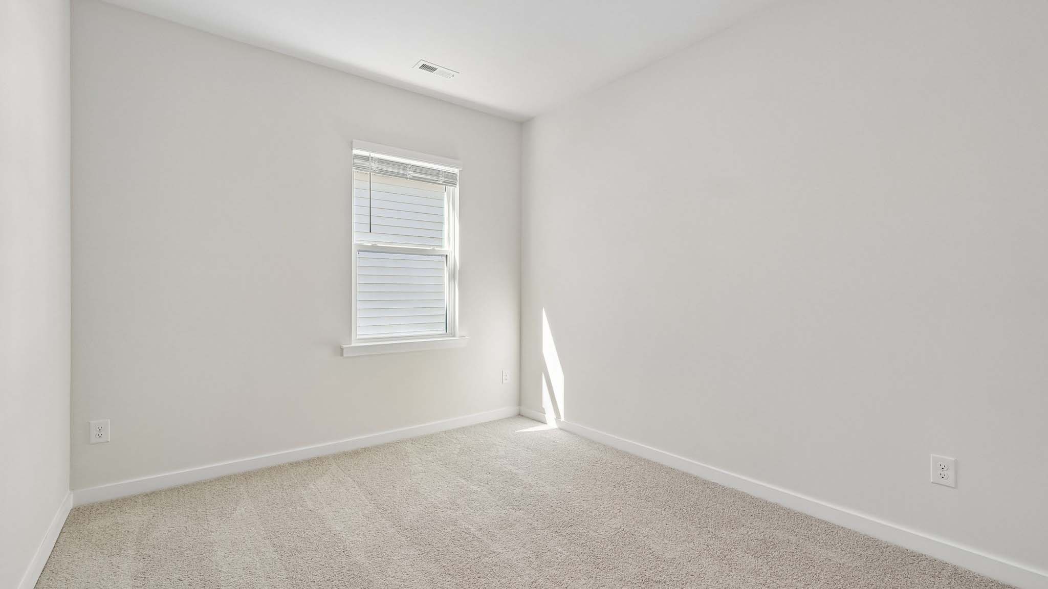 Carpeted bedroom with window