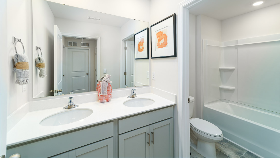 Bathroom with bathtub and double sinks