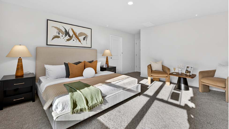 Primary carpeted bedroom with large window, view of bathroom door