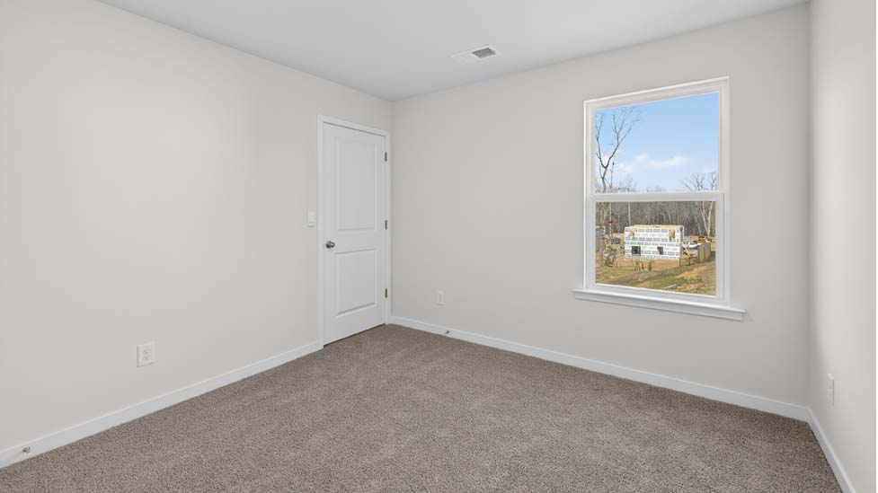 Carpeted bedroom  with small window