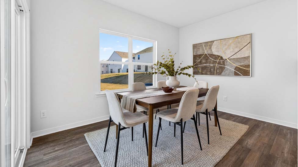 Breakfast area with wood floors, large window, and sliding glass back door