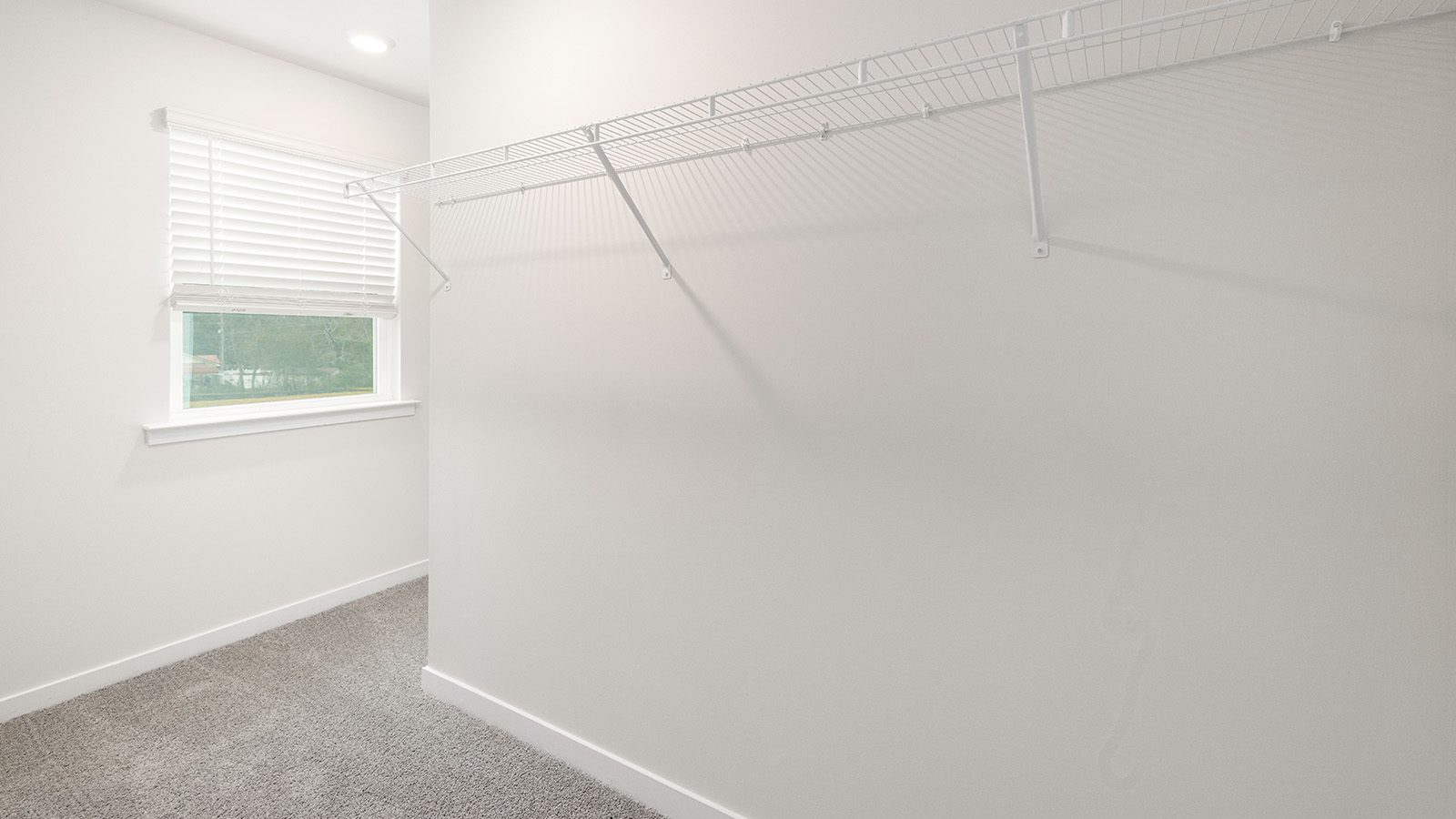 Carpeted bedroom  with small window