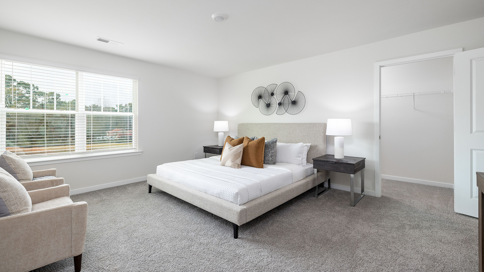Carpeted bedroom with large window, view of bathroom door