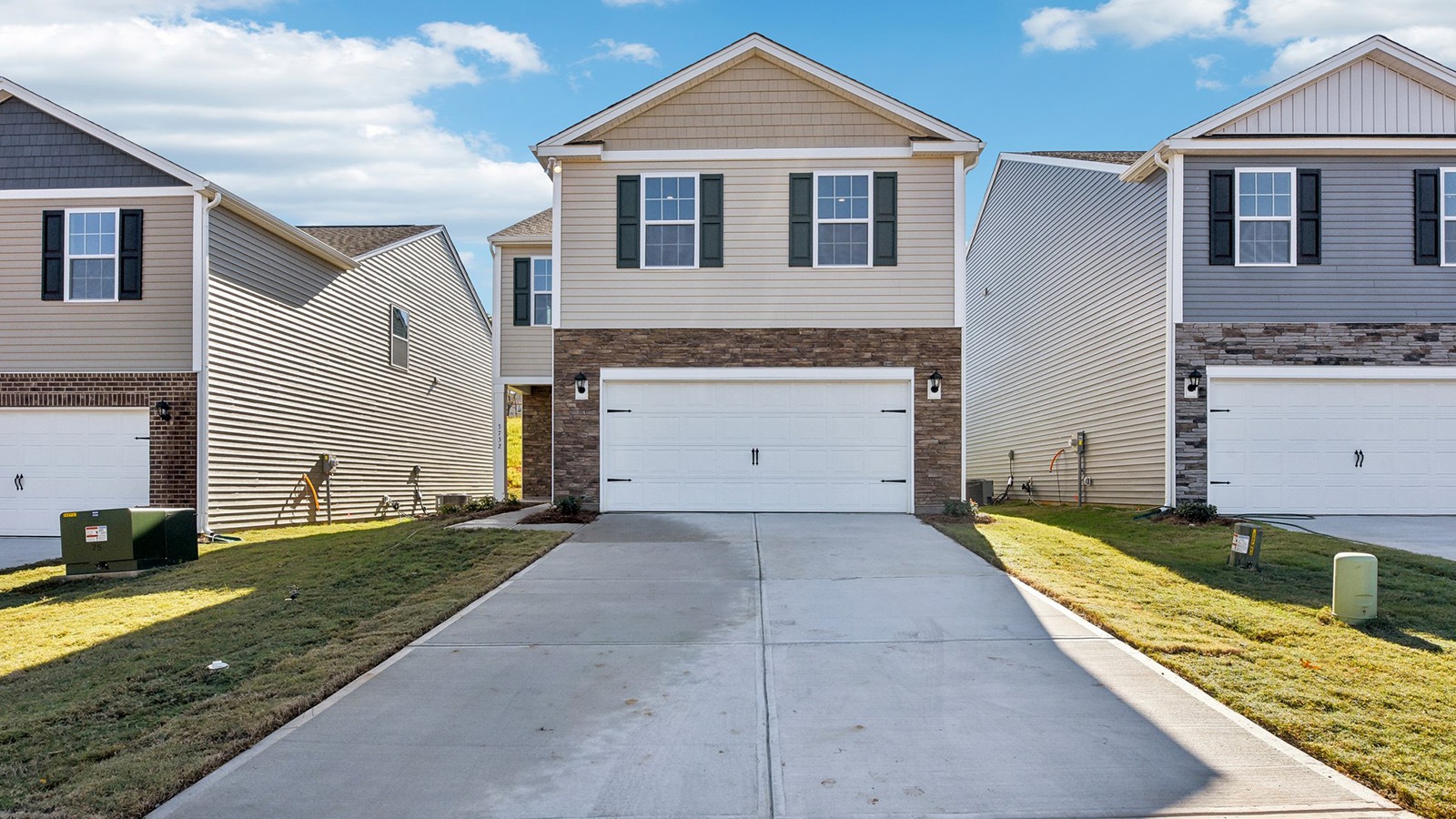 Aisle front exterior with siding and two car garage