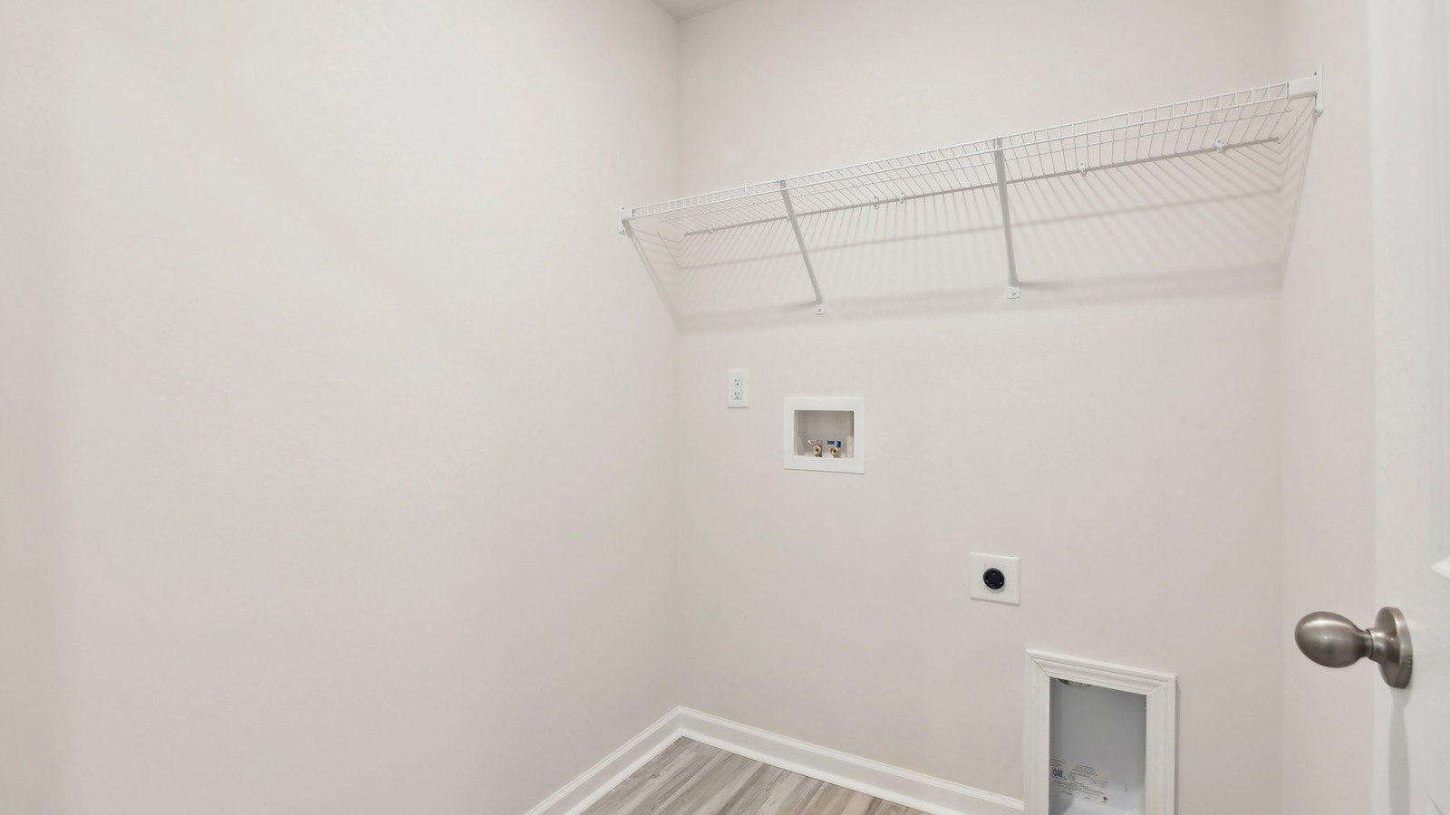 Laundry room with over machine racks for storage