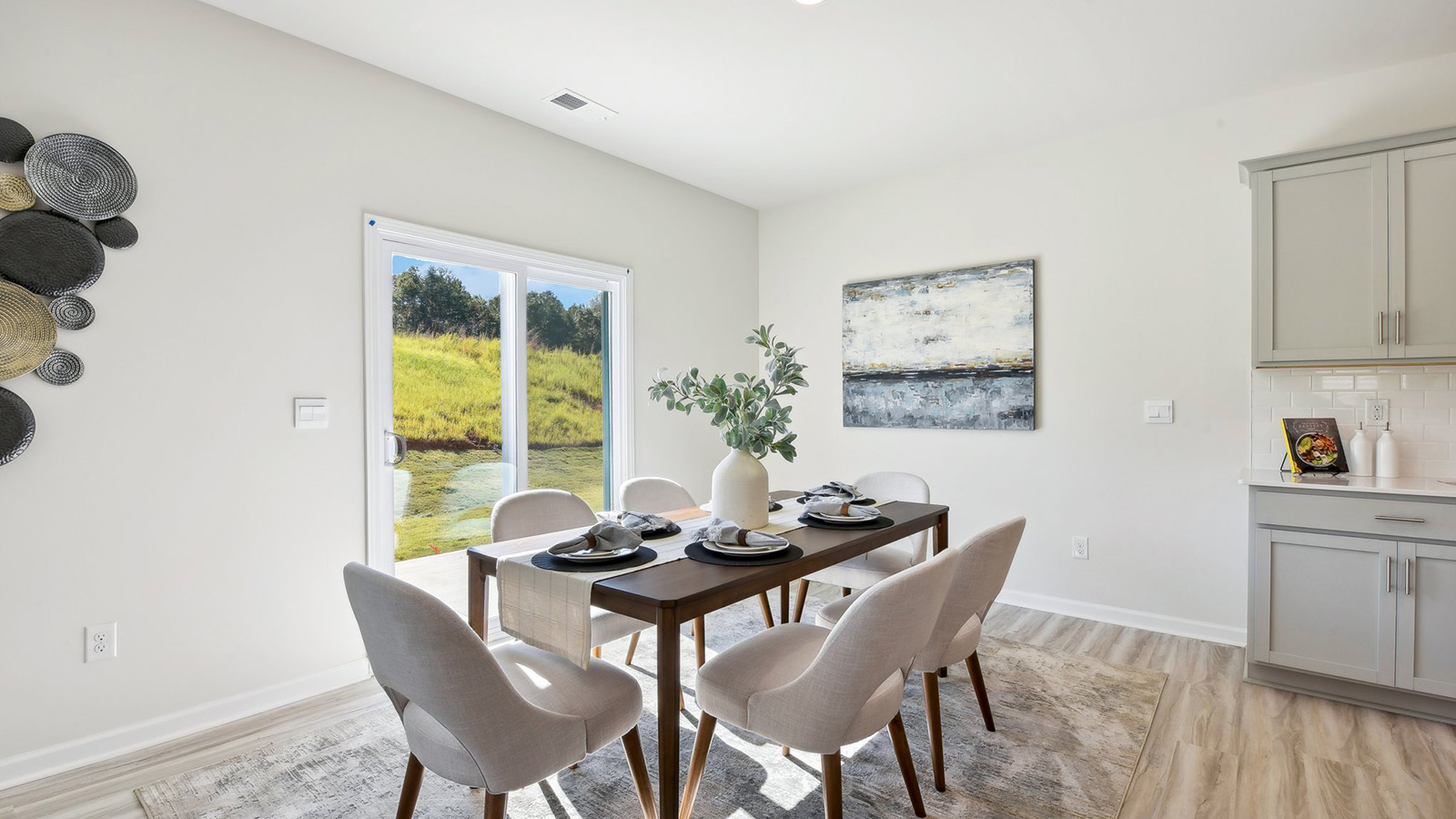 Open dining area near kitchen, with sliding glass doors