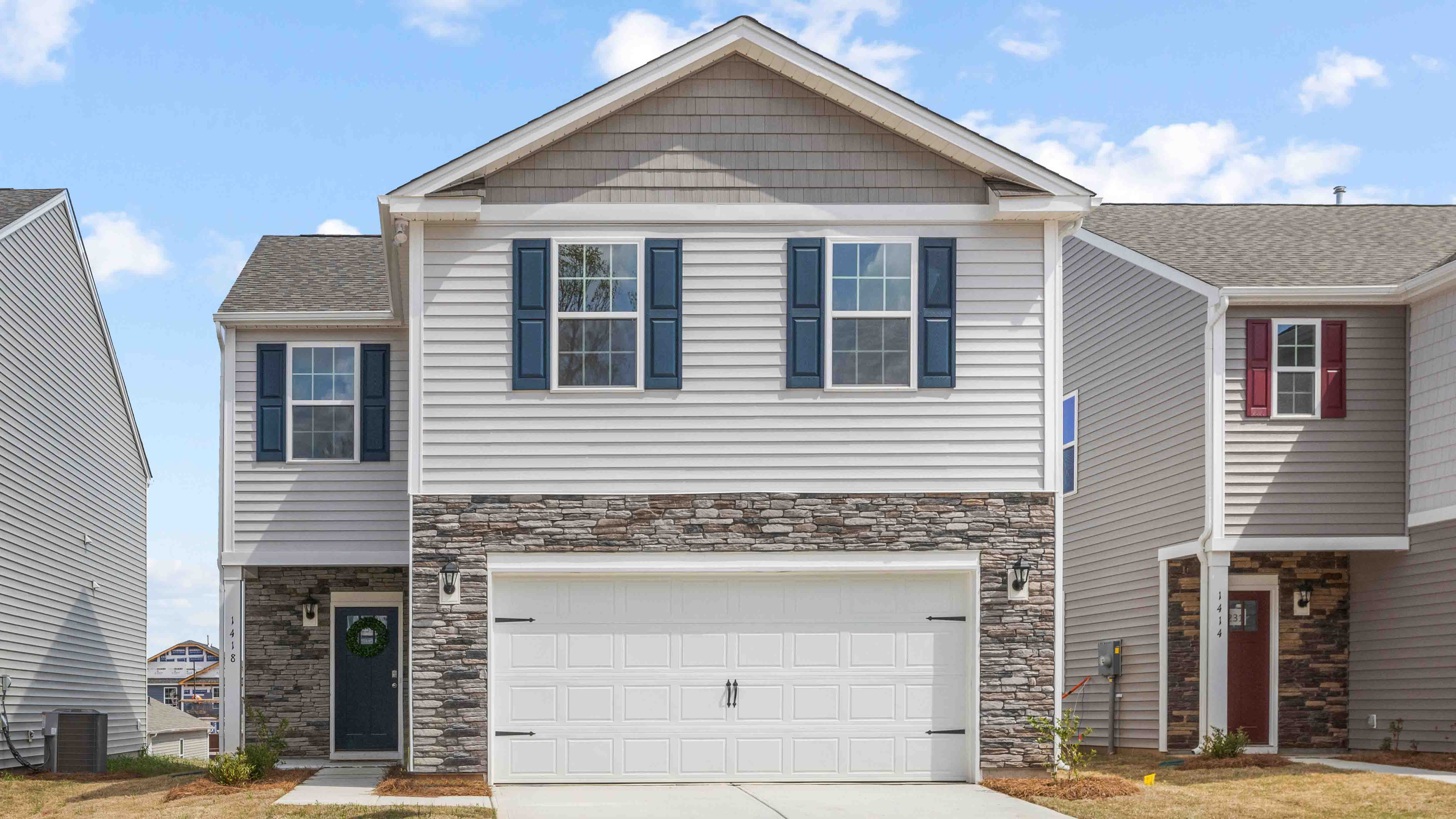 Aisle front exterior with siding and two car garage
