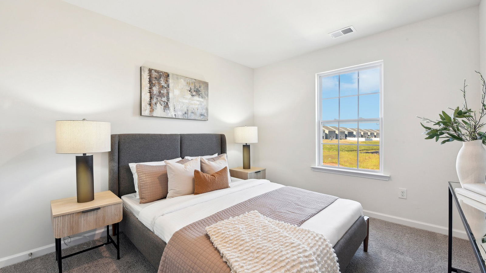 carpeted bedroom with large window