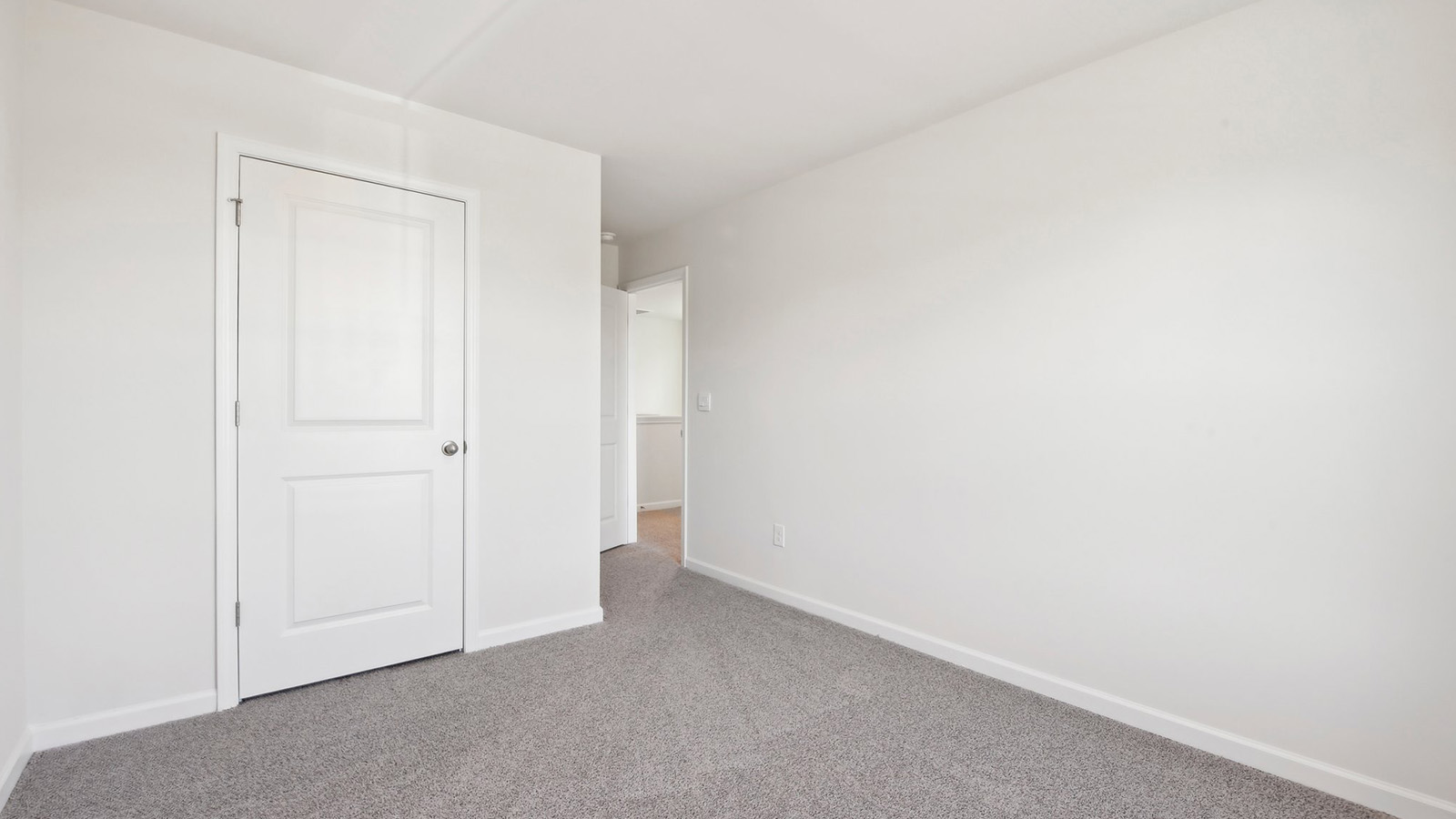 carpeted bedroom with large window