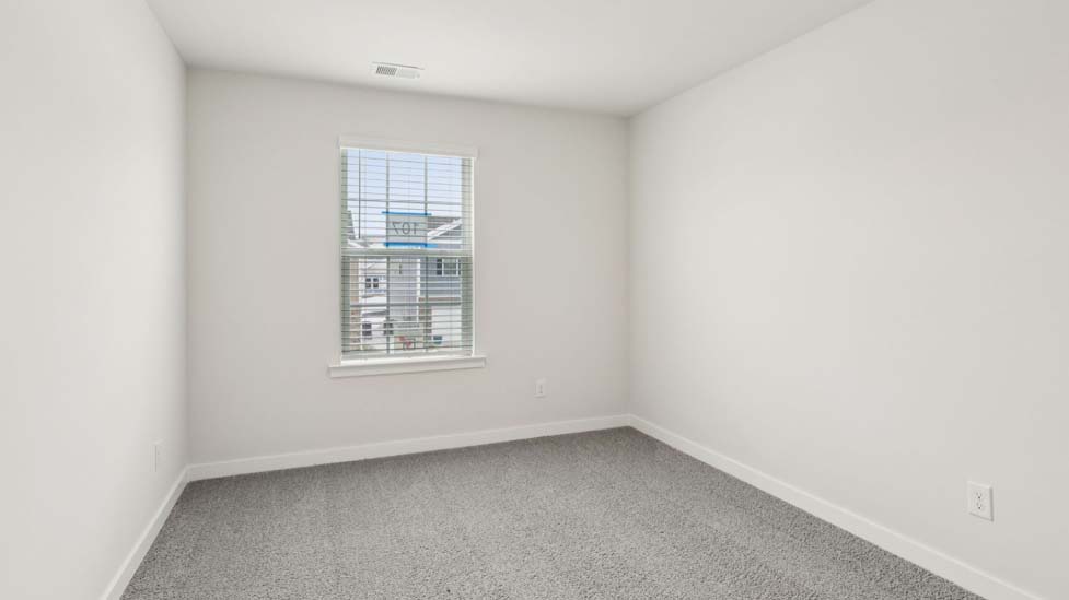 Carpeted bedroom with large window