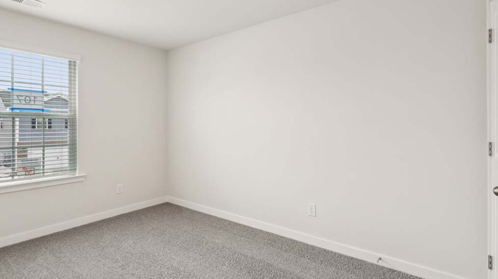 Carpeted bedroom with large window