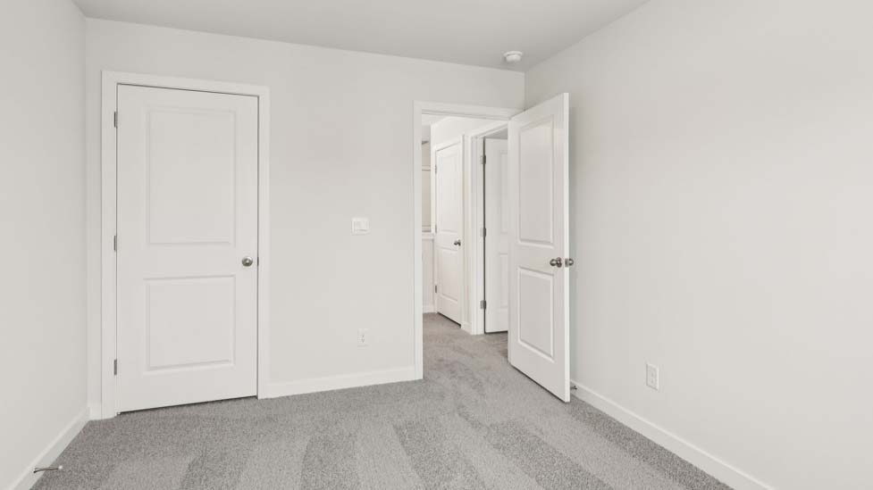 Carpeted bedroom with large window