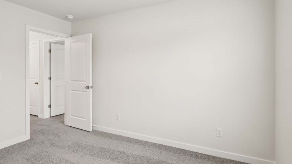 Carpeted bedroom with large window