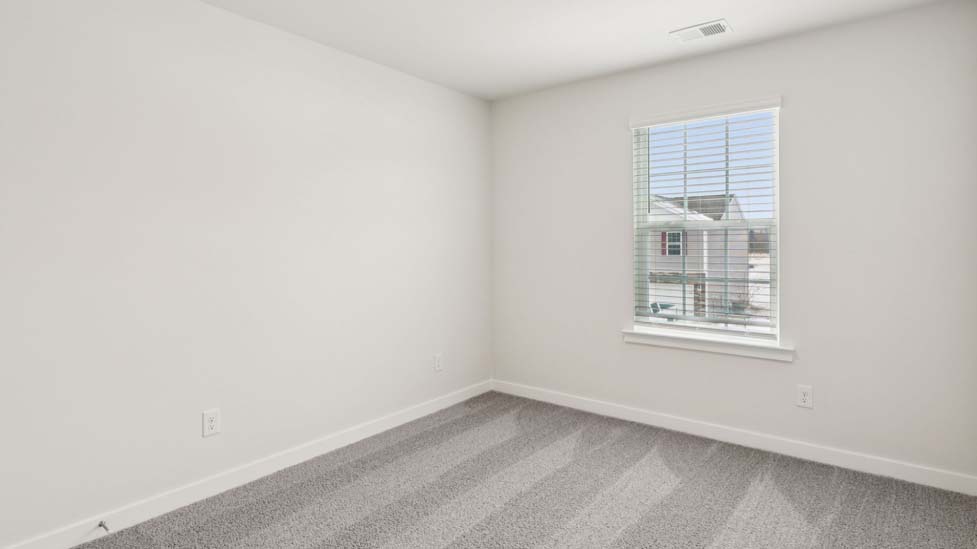 Carpeted bedroom with large window