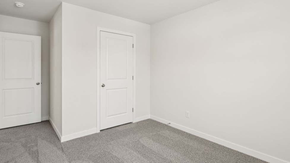 Carpeted bedroom with large window