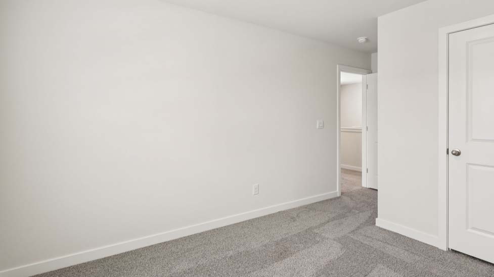 Carpeted bedroom with large window