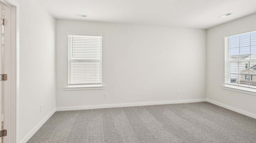 Carpeted bedroom with large window