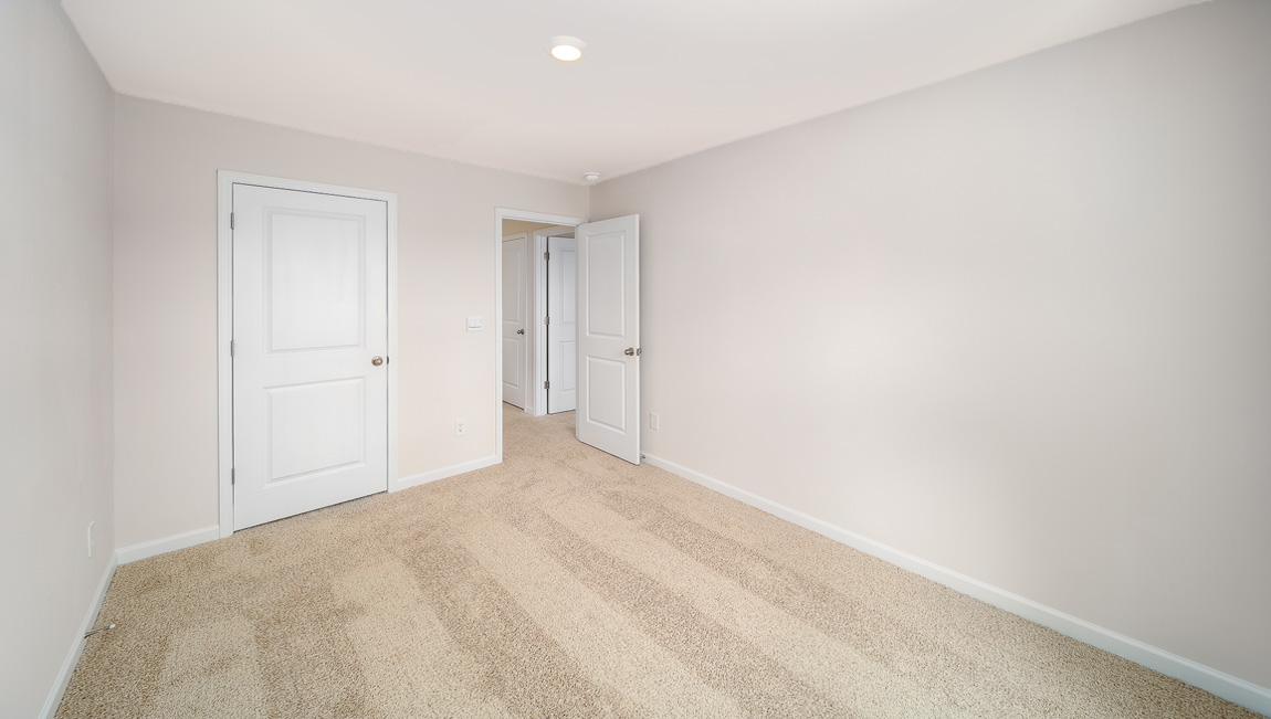 Carpeted bedroom with window