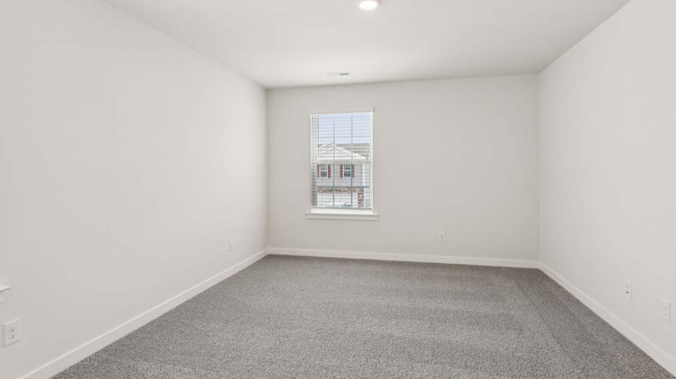Carpeted bedroom with large window