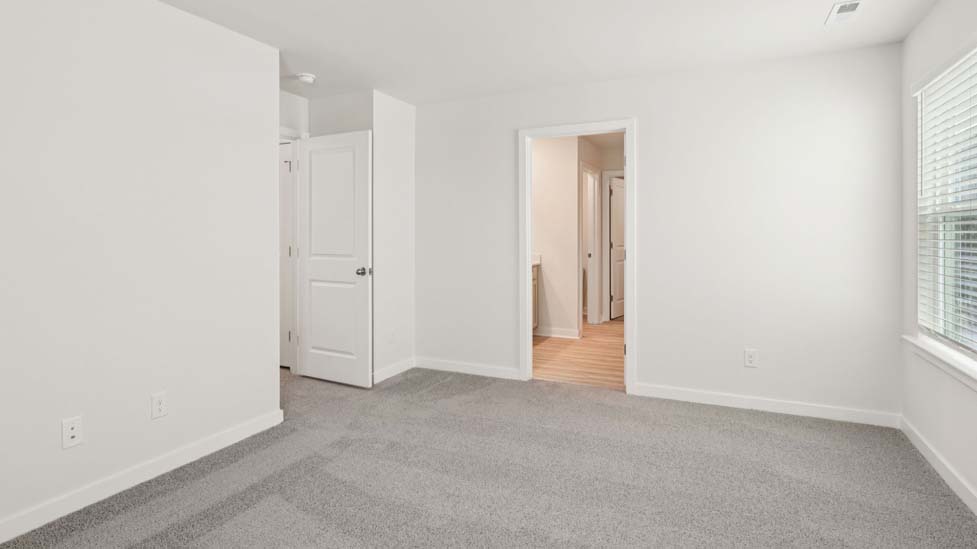 Carpeted bedroom with large window