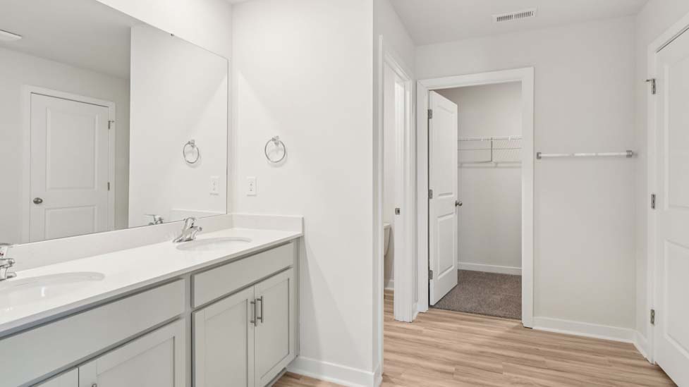 Bathroom with double sink vanity and walk in shower