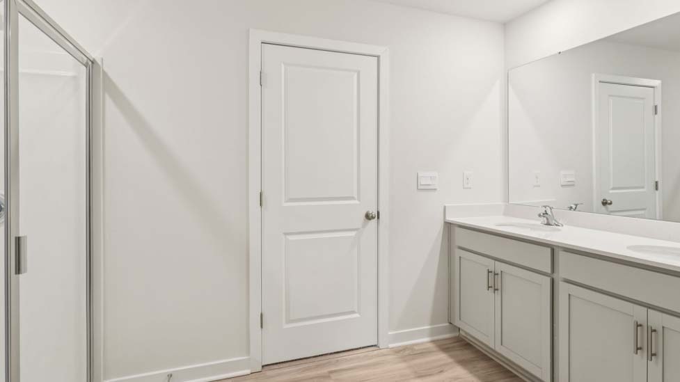 Bathroom with double sink vanity and walk in shower