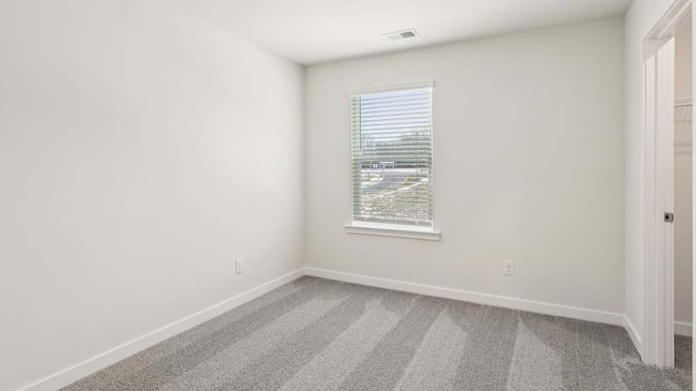 Carpeted bedroom with large window